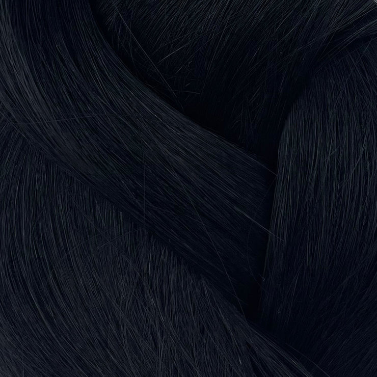 Genius Miracle Micro W wefts showcased in a stylist's hands, highlighting their ultra-thin construction. Perfect for fine hair, these wefts offer a virtually undetectable finish for a flawless look