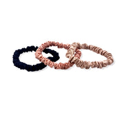 Luxurious silk scrunchies safe for hair, designed to prevent breakage and eliminate kinks for smooth, healthy hair