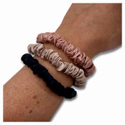 Luxurious silk scrunchies safe for hair, designed to prevent breakage and eliminate kinks for smooth, healthy hair
